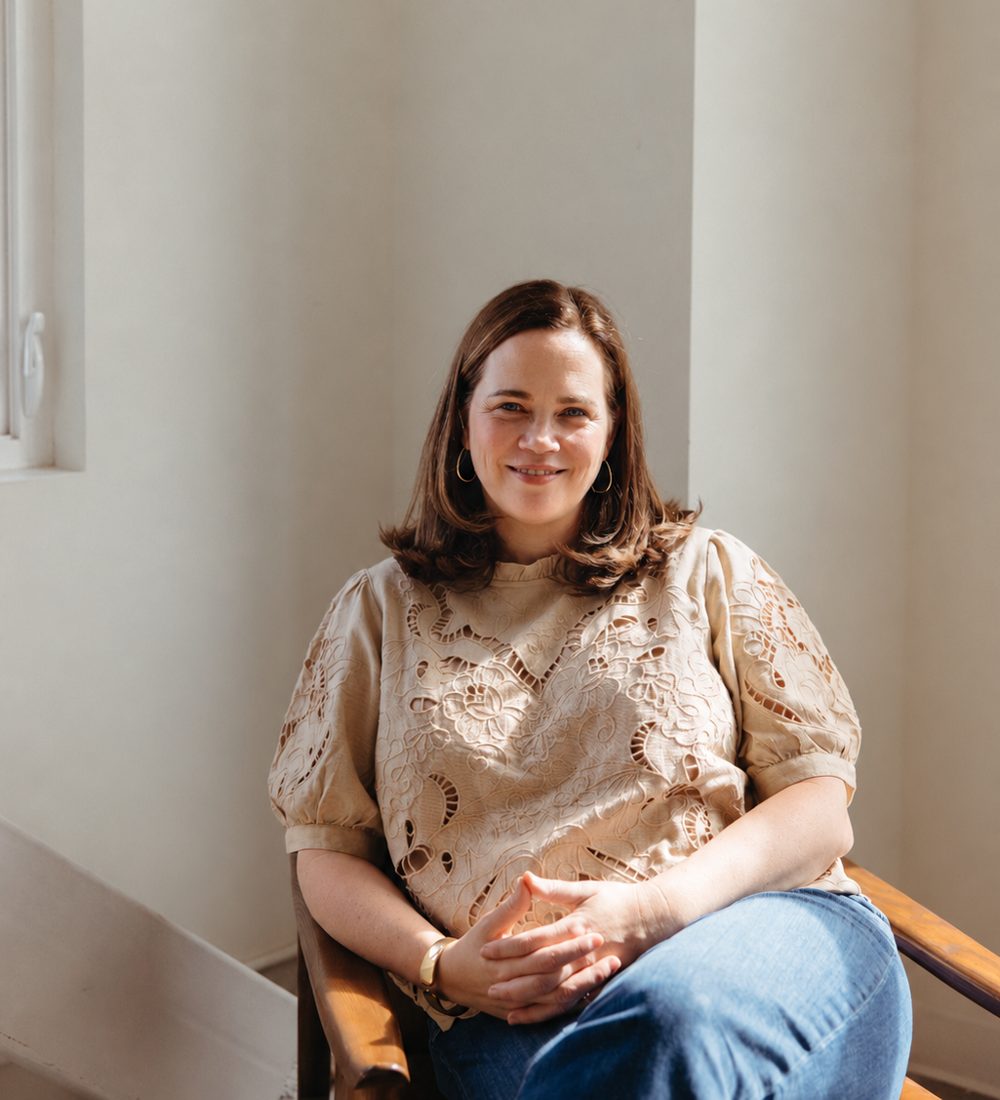 Sarah Kaehn seated in a sunlit chair